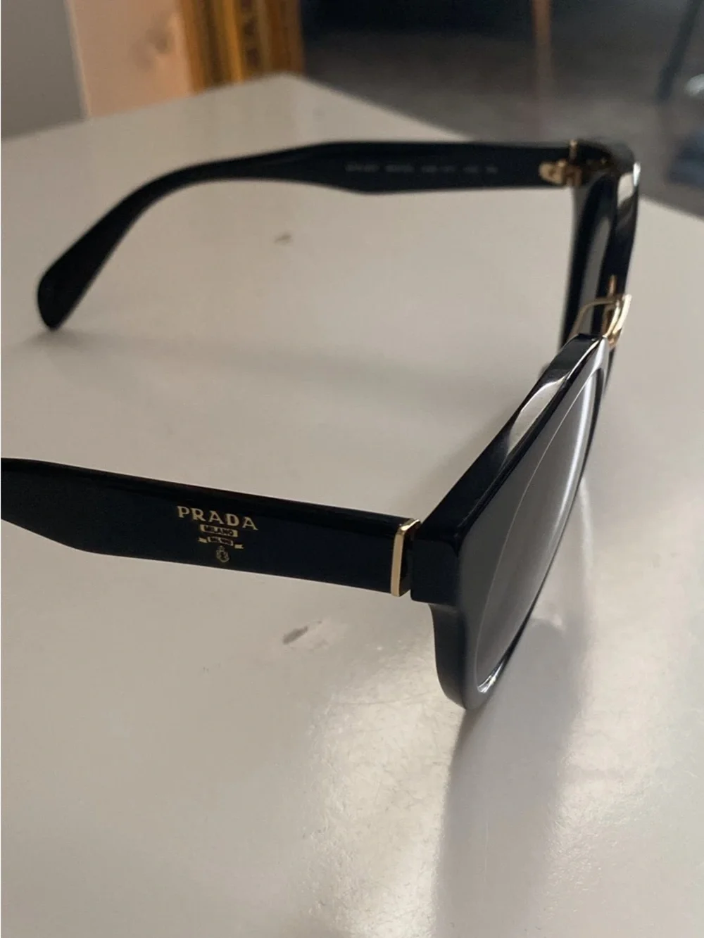 Prada Black Round Sunglasses with Gold Detailing